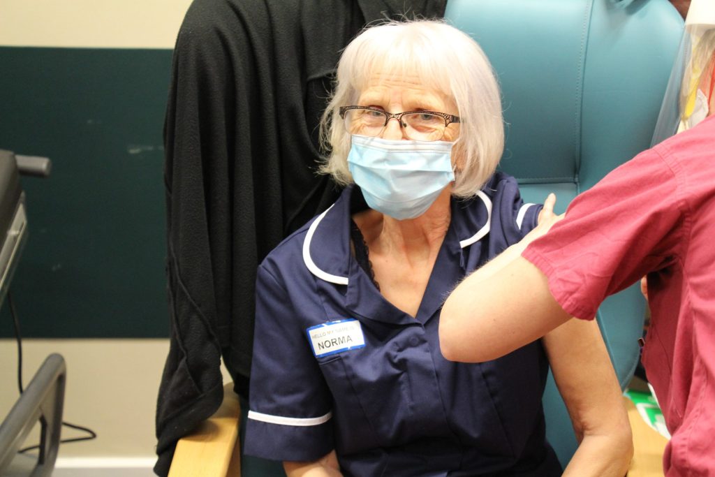 Norma getting her vaccine.