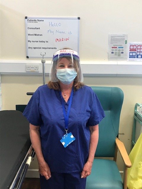 Marion Riordan wears a face mask and face shield.