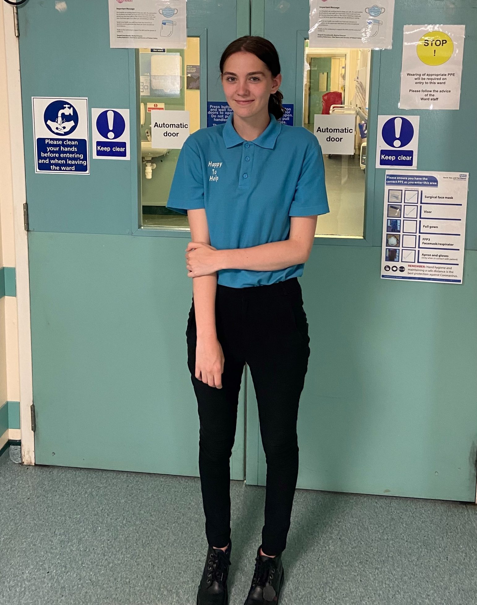 Sarah Barker stands in a corridor.