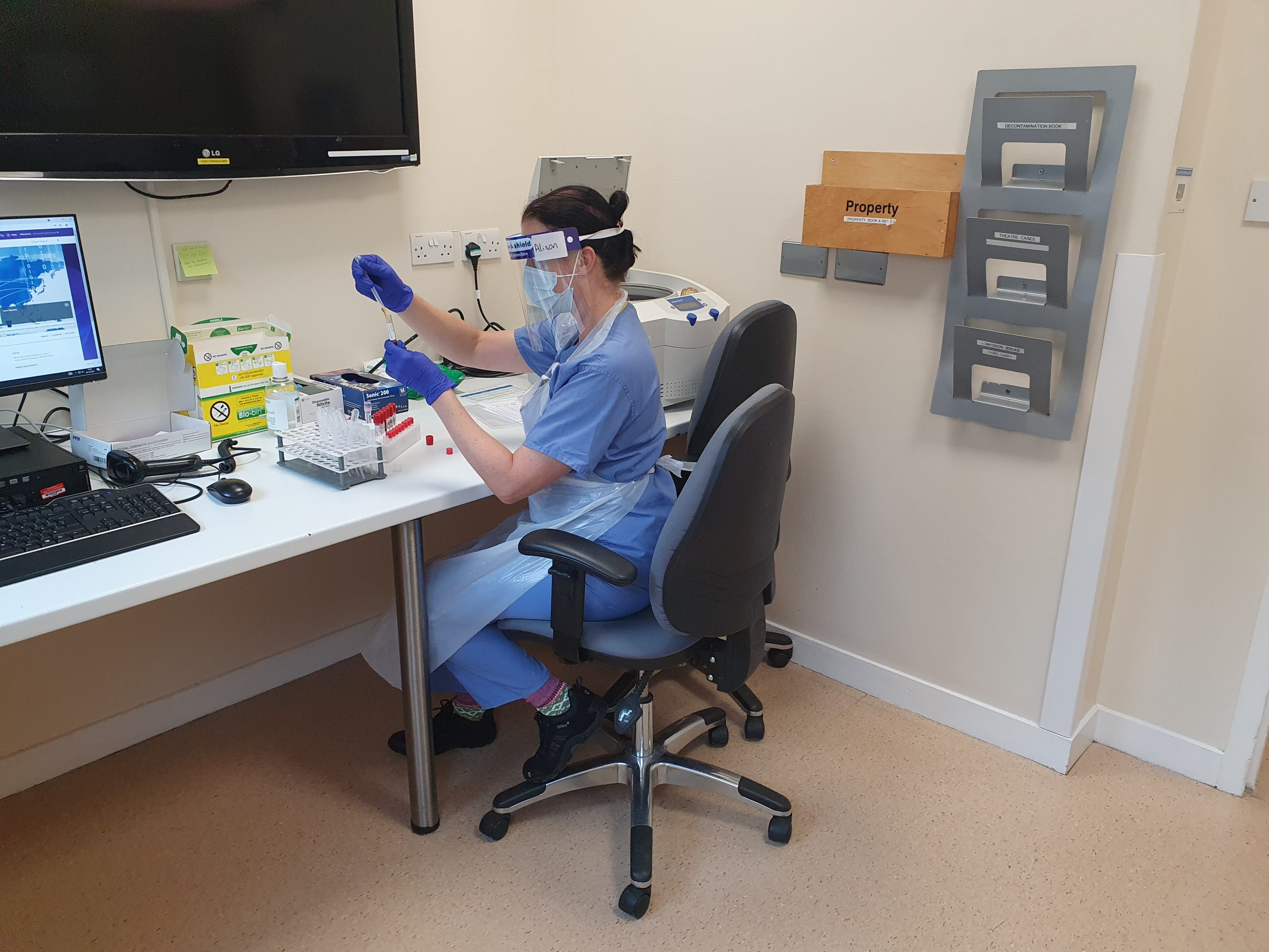 A member of staff testing a blood sample.