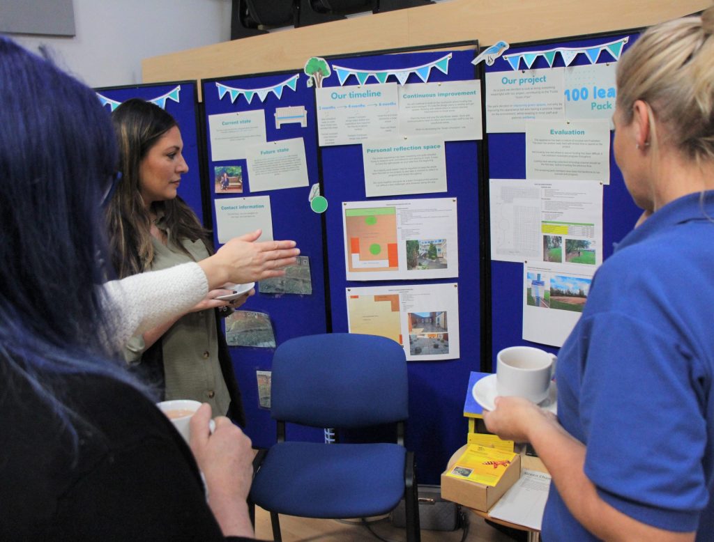 Pack 5 of the 100 leaders programme explain their project to event attendees.