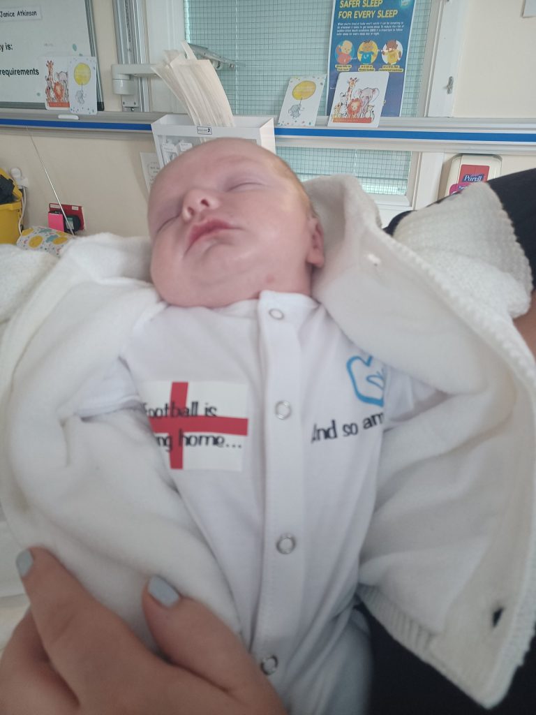 Baby Louis. He is wearing a onesie which reads: "Football is coming home... And so am I."