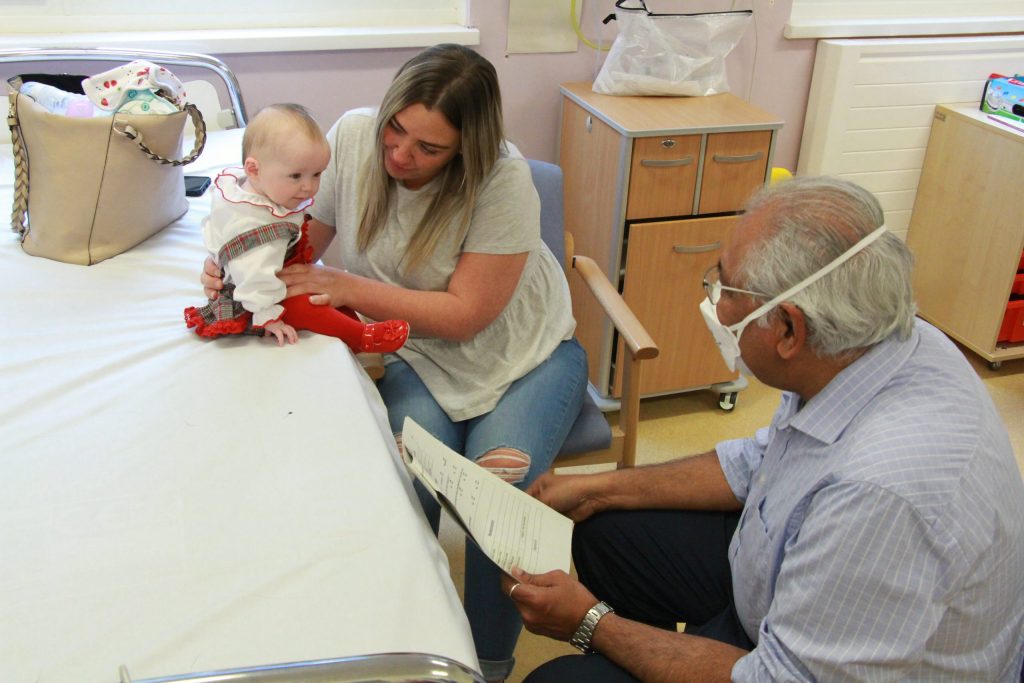 Baby Aubrey being examined by Dr. Harikumar.