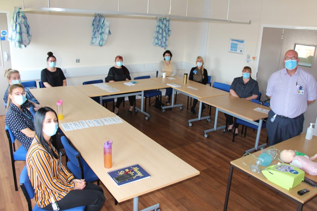 Staff sit around a table.