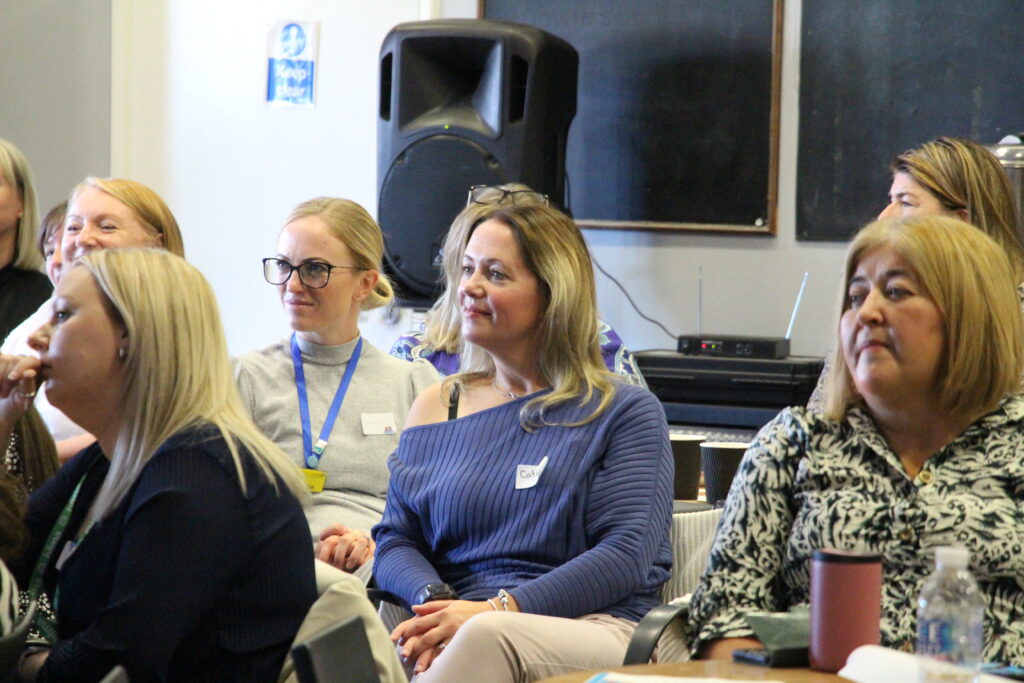 Attendees sit in the audience.