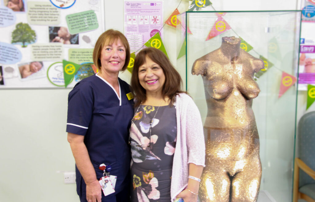 Staff stand by statue of pregnant woman in the maternity assessment unit waiting room at the University Hospital of North Tees.