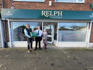2. Staff from drop off point, Relph Funeral Directors, handing over the hearing aids to Zoe Fawcett-Eustade