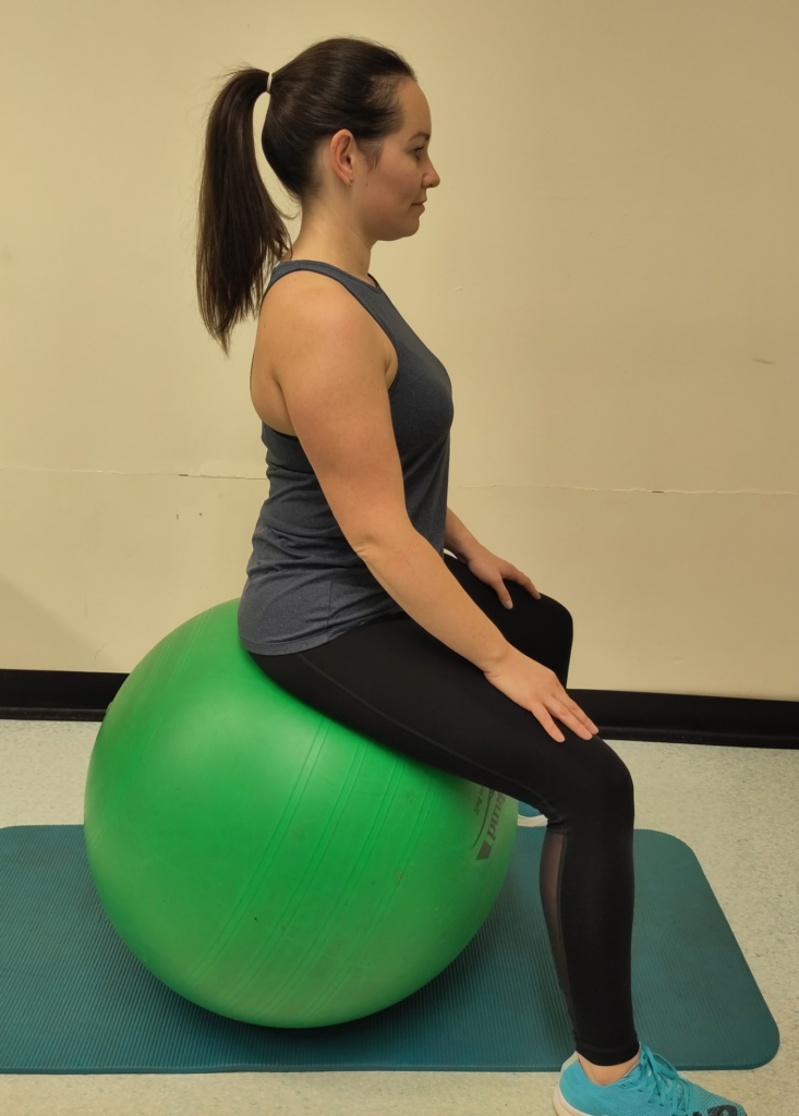 the correct posture when sitting on an exercise ball.