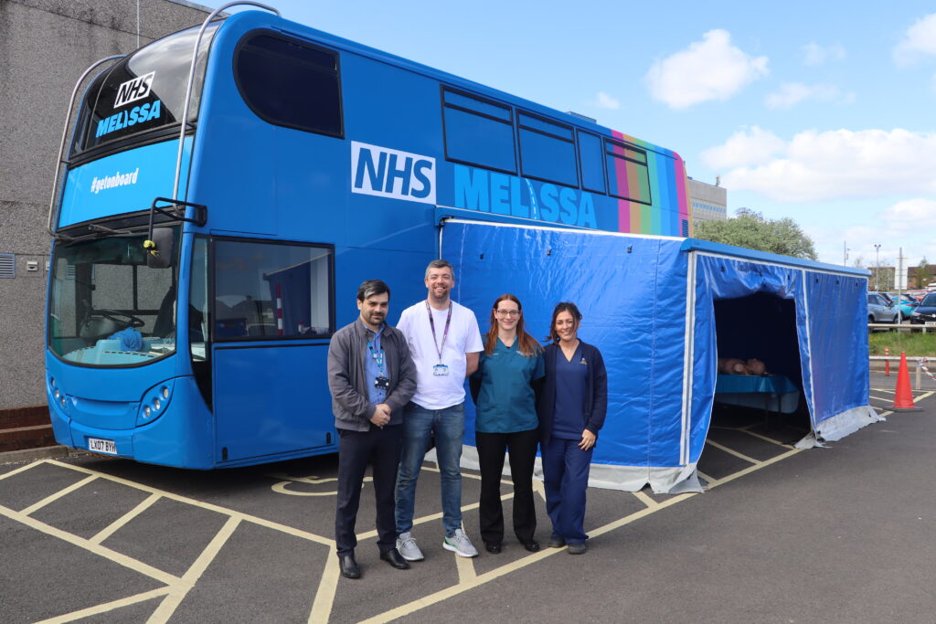 Stephen Cooper, service lead for the MELISSA training bus, Jonathan Laws, emergency medicine and education fellow trust registrar, Kate Williamson, emergency department consultant, Danielle Jamieson, simulation clinical educator stand i front of the MELISSA Bus.