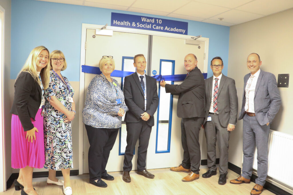 Key stakeholders cutting the ribbon on the new health and social care academy