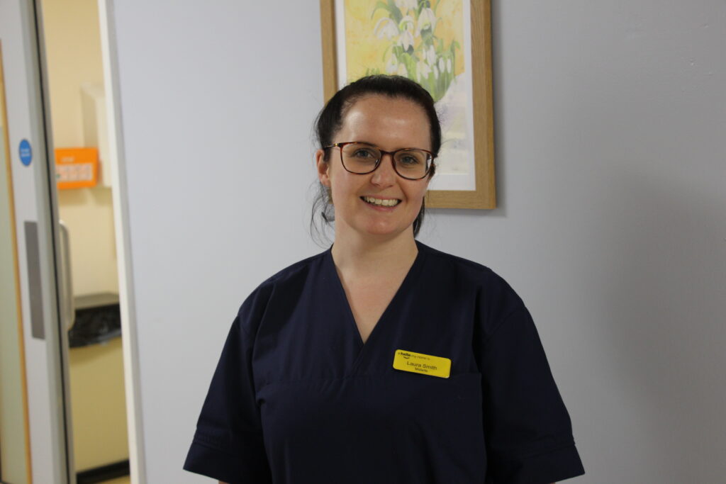 Bereavement midwife standing in corridor for photo.