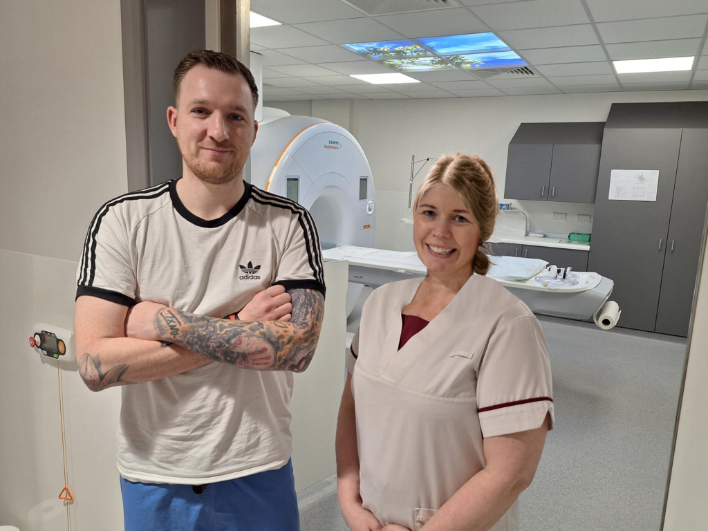 Patient stood with staff member for photo.