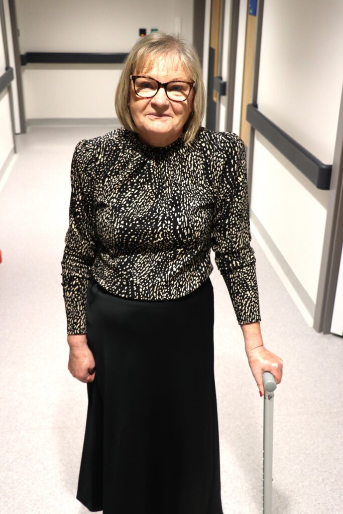 Patient stood in corridor.