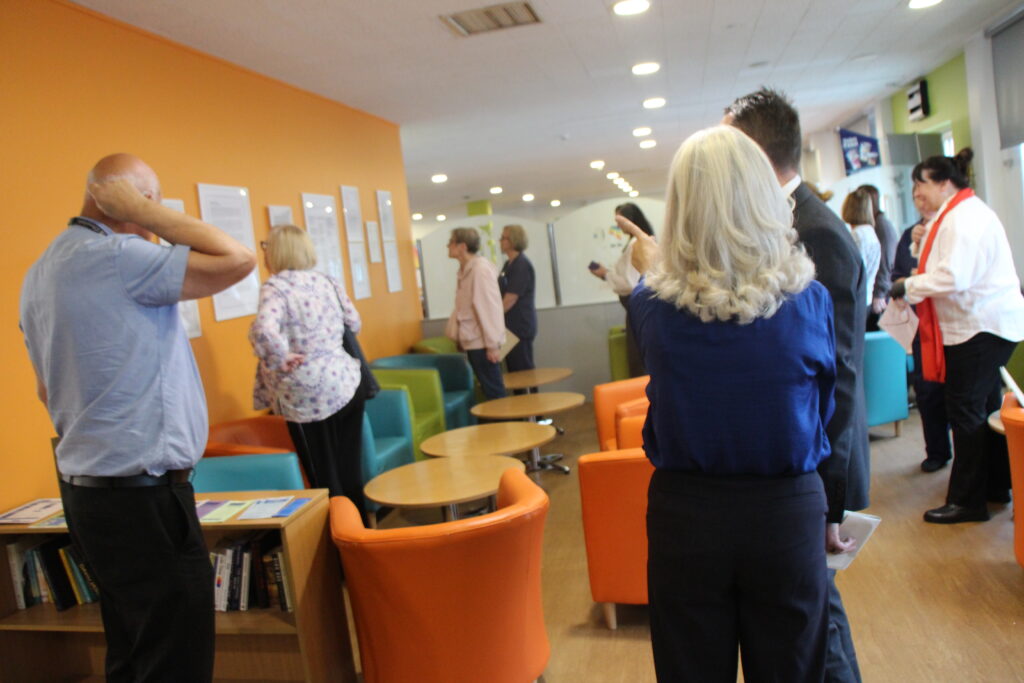 Colleagues gather for the launch of the writers' nook