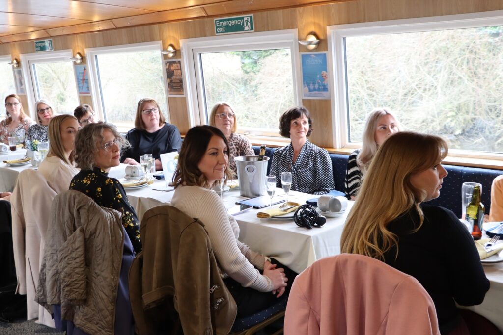 A group of women sit at a table.