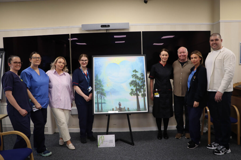 Mackenzie Thorpe and parents Alice and Michael, with their sister and some of the maternity staff involved in Angelo's care