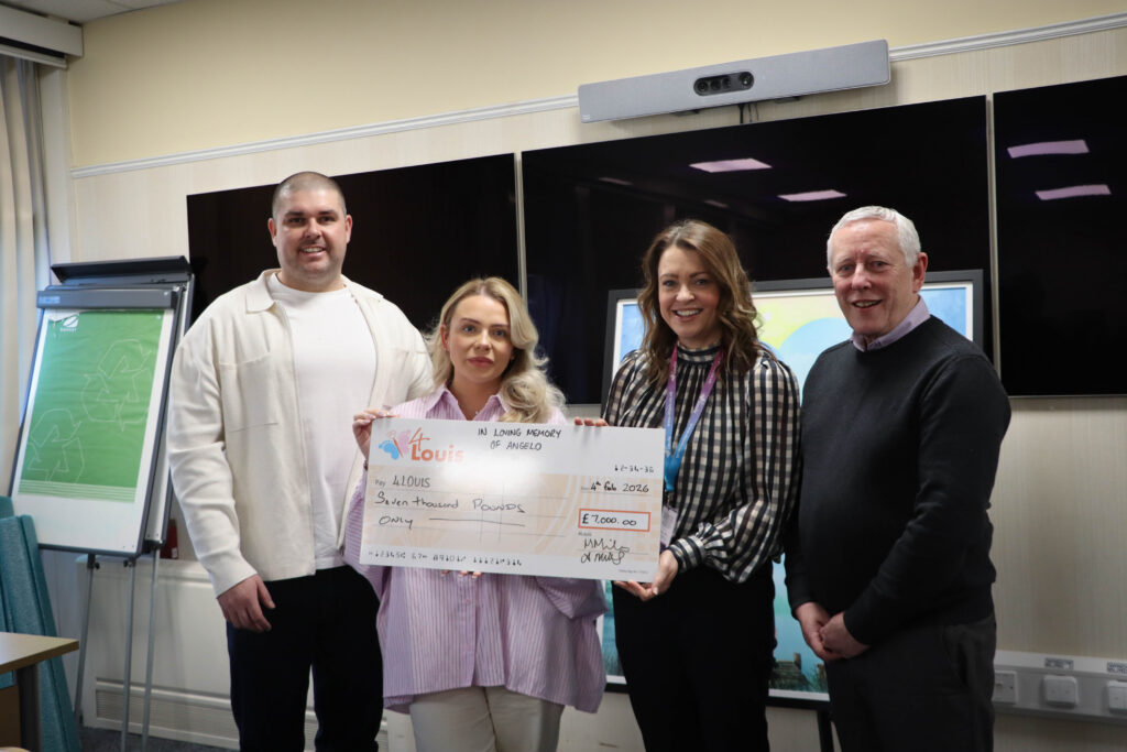 Parents Alice and Michael donating funds raised to 4Louis