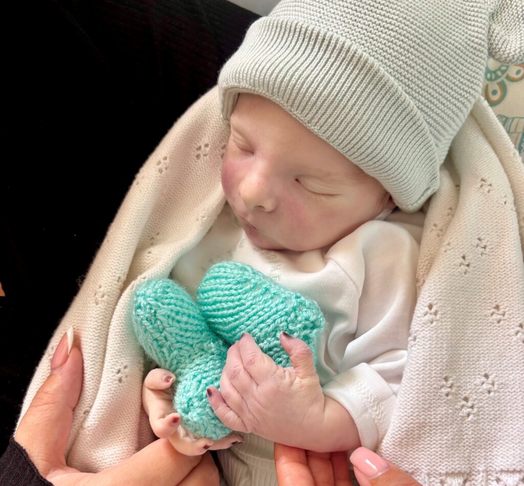 Little Angelo with the two blue knitted hearts