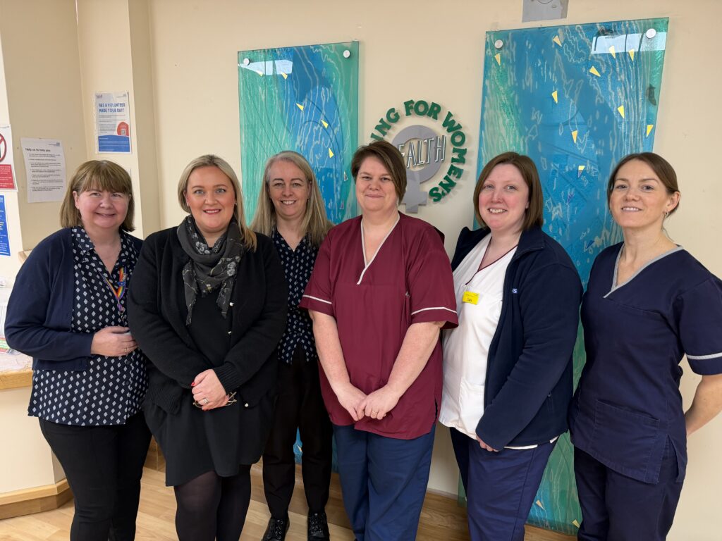 The breast screening team - Paula Wood, programme clinical administrator centre in red tunic