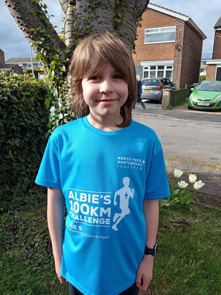 Albie Rice. He wears a blue t-shirt which reads "Albie's 100km challenge".