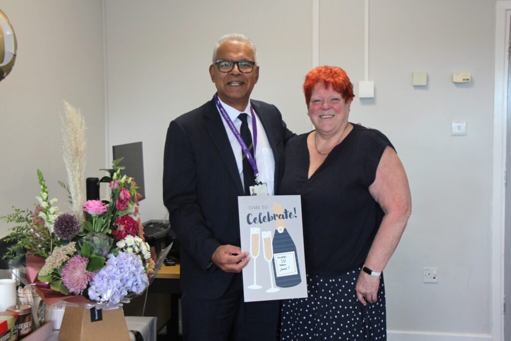 Deepak Dwarakanath presenting Janet Alderton a celebration card
