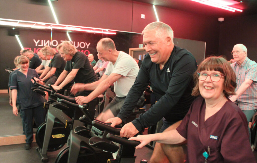 Janine O'Rourke with Mike Ritchie on exercise bike