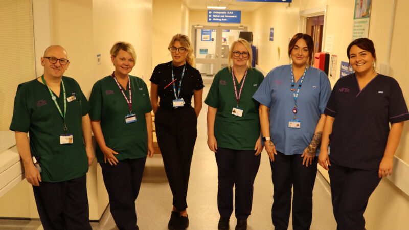 Alcohol care team stood in corridor.