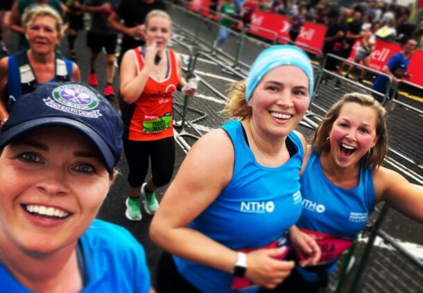 Three people running in the Great North Run. They wear t-shirts which read 'North Tees and Hartlepool Together'.