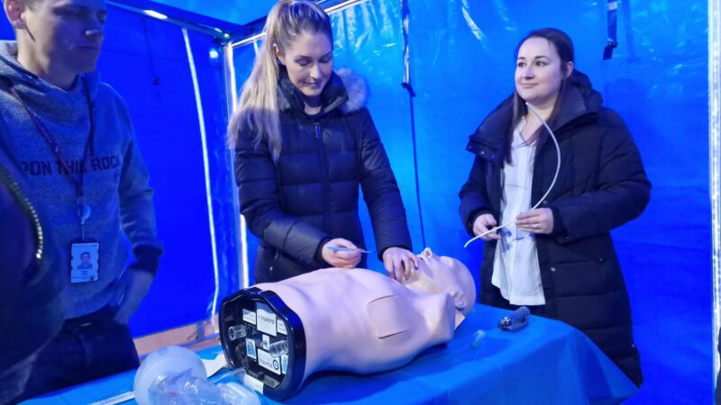 Dr Ryan Clark, Acute Schools Emergency Medicine Training, leads two emergency medicine doctors-in-training on a practical session in the MELISSA bus