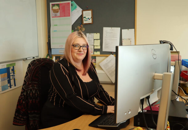 Clinical effectiveness co-ordinator, Lisa Pickering sits at her desk