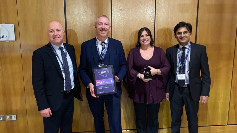 Carescan team standing with award.
