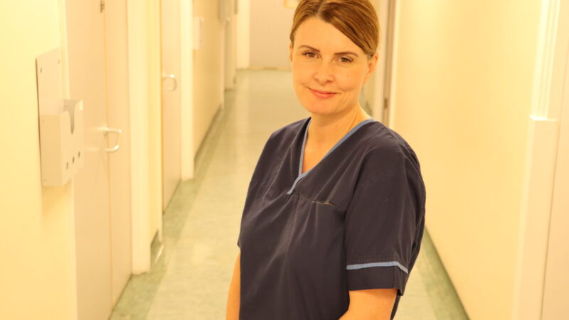 Midwife standing in corridor.