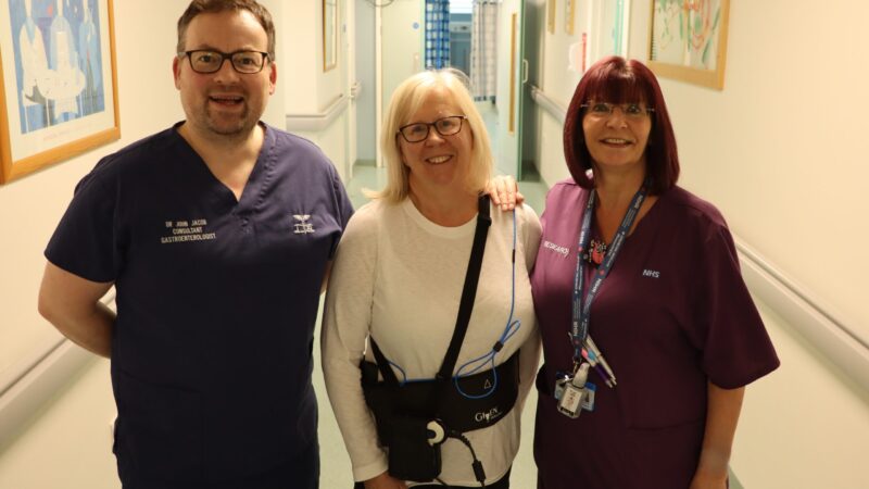 Research team and a patient standing in the corridor.