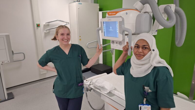 Two staff members standing in a scanning room.