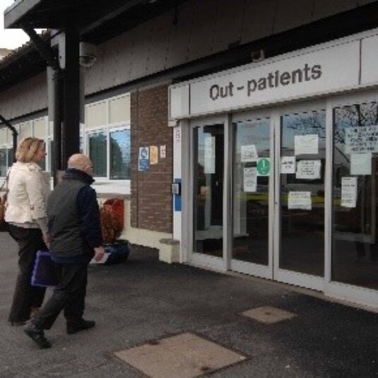 Patient and carer outside of entrance to outpatients