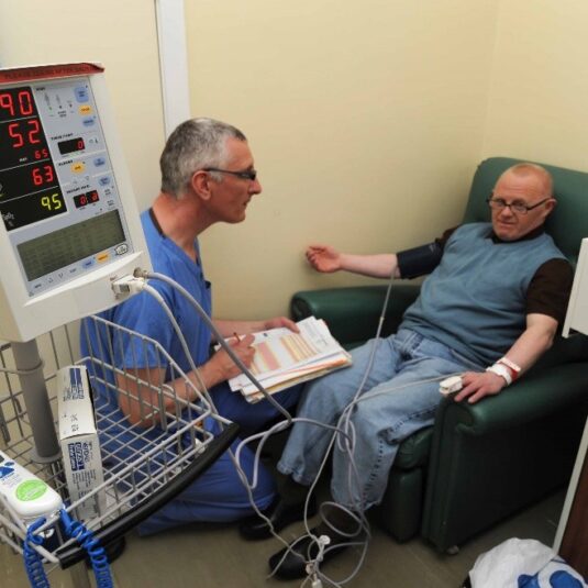 nurse checks a patients blood pressure