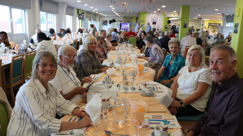 Volunteers sitting at a table ahead of the event.
