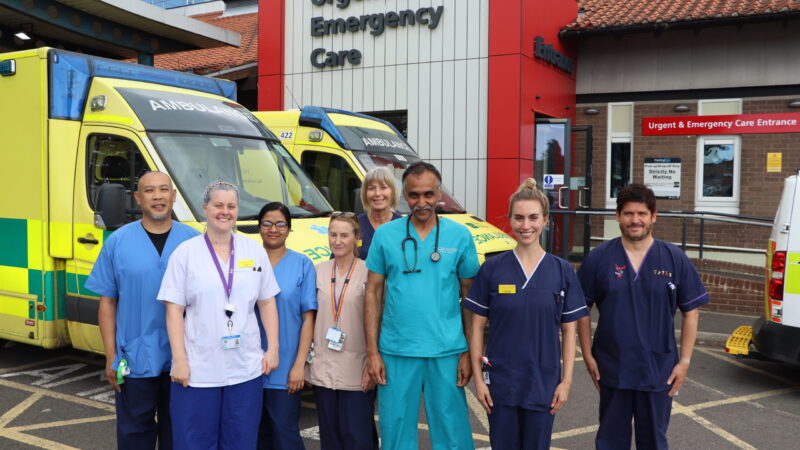 Emergency care team stood in front of department.