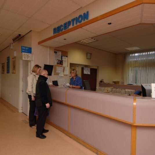 Patient and carer at outpatient reception