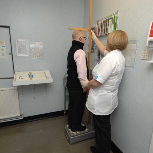 Patient getting measured by the nurse