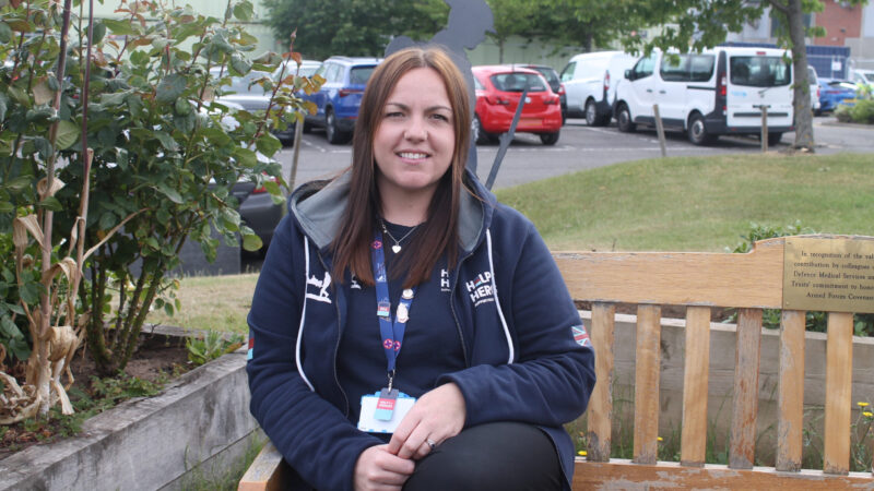 Hannah Robertson sits on a bench outside.