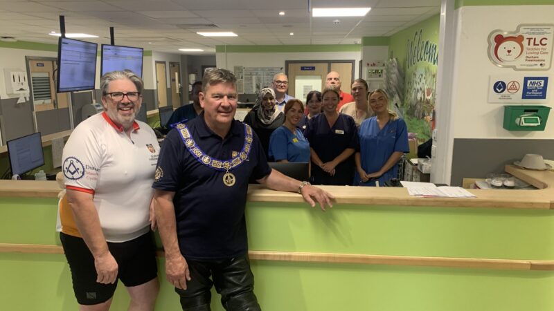 Freemasons visit paediatric outpatients following charity bike ride.
