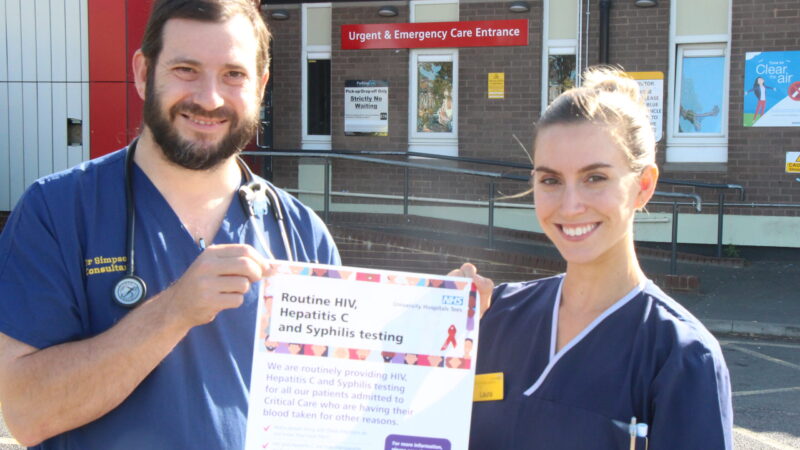 Dr George Simpson, consultant in emergency medicine at University Hospital of North Tees, and emergency department matron Laura Pennicott with a poster advising patients of the testing for blood diseases.