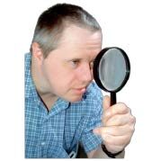 man looking through magnifying glass
