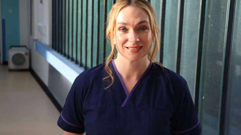 Martha' Rule nurse stands in corridor for photo.