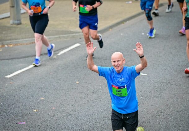 A man running. His arms are in the air.