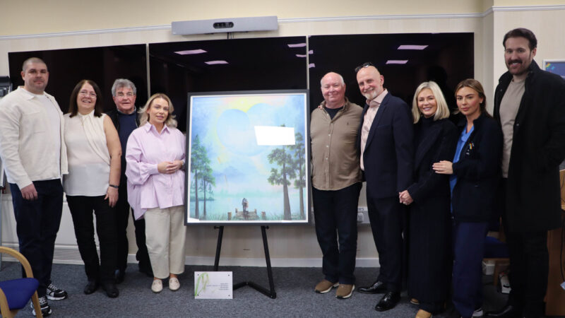 The family and Mackenzie Thorpe stand around the newly unveiled piece