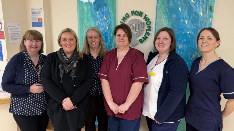 The breast screening team - Paula Wood, programme clinical administrator centre in red tunic