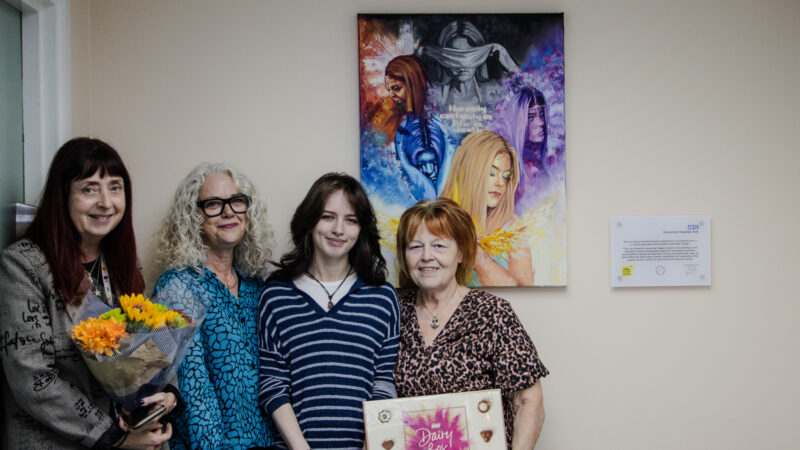 (L - R) Liz Dixon, Jean MacLeod, Cara Ramsey and grandmother Inga Ramsay stand beside the 5 Stages of Grief arwork in situ at the University Hospital of North Tees.