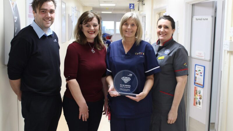 Debbie accepting award from colleagues